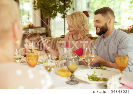 Loving blonde-haired mommy touching head of daughter 54348022