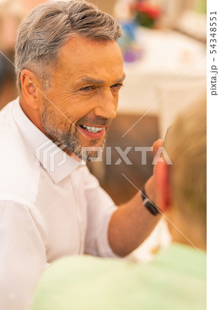 Handsome bearded grey-haired man looking at his wife 54348551