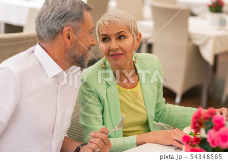 Mature woman with facial wrinkles looking at handsome husband 54348565