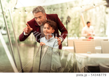 Handsome cute son standing near father on summer terrace 54348779