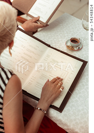 Husband and wife sitting at the table deciding what to order 54348814