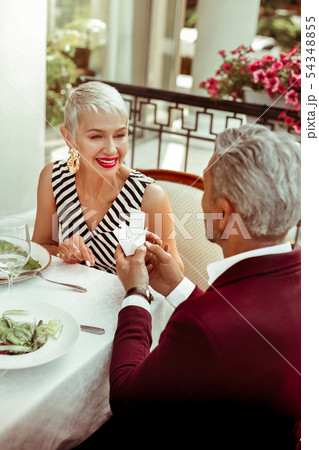 Grey-haired mature businessman presenting jewelry for his wife 54348855