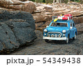 Toy car on mountain rock background, miniature 54349438