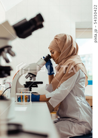 Serious thoughtful woman studying test samples in the bio lab 54350422