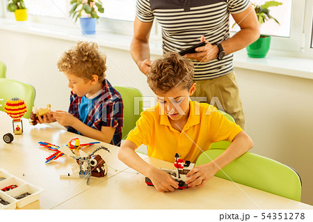 Top view of a nice cute boy looking at the boat Top view of a nice cute boy looking at the boat 54351278