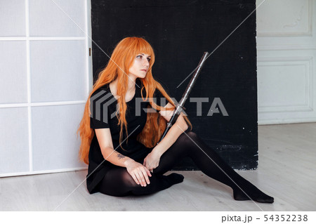 young woman in japanese anime cosplay, holding samurai sword. young woman in japanese anime cosplay, holding samurai sword. 54352238
