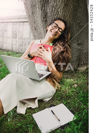 Student learning lessons with laptop in park 54352428