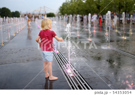 Little boy plays in the square between the water 54353054