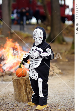 Little boy in scary skeleton costume on background 54354472