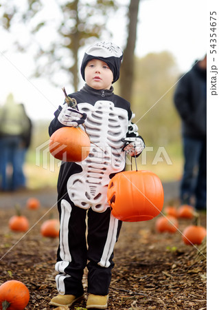 Little boy in scary skeleton costume at halloween 54354675