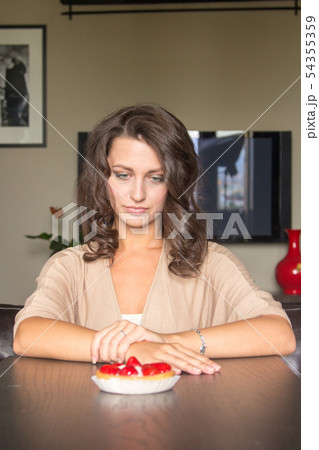 Pretty girl Looking to strawberry cake 54355359