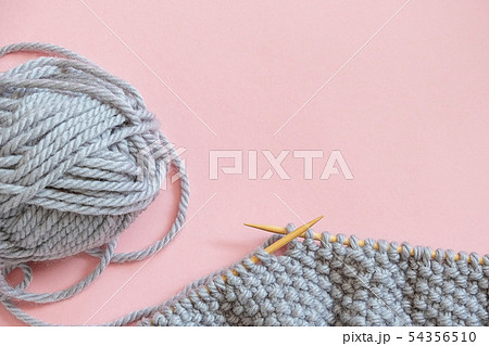 Piece of grey knitted fabric on bamboo wood Piece of grey knitted fabric on bamboo wood 54356510