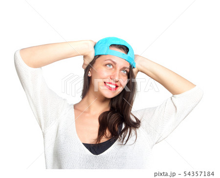 Attractive young woman wearing a blue baseball cap Attractive young woman wearing a blue baseball cap 54357184