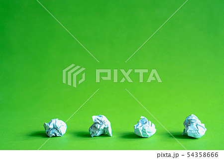 Trash ball paper crumpled isolated on green 54358666