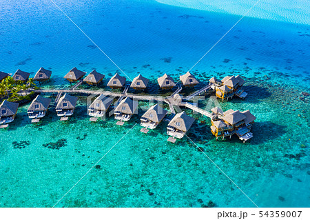 Travel vacation paradise aerial image with overwater bungalows in coral reef sea 54359007