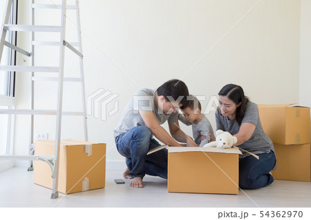Happy Asian family with cardboard boxes new home Happy Asian family with cardboard boxes new home 54362970