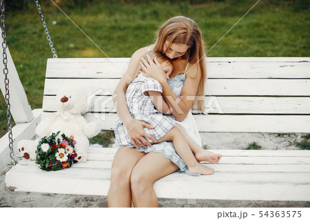 Mother with daughter playing in a summer park Mother with daughter playing in a summer park 54363575