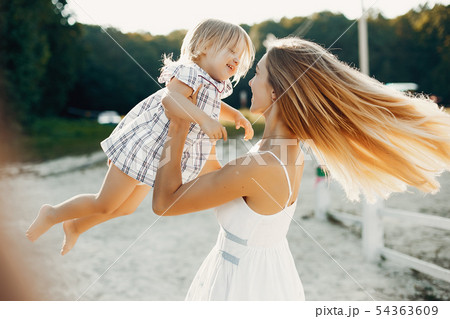 Mother with daughter playing in a summer park Mother with daughter playing in a summer park 54363609