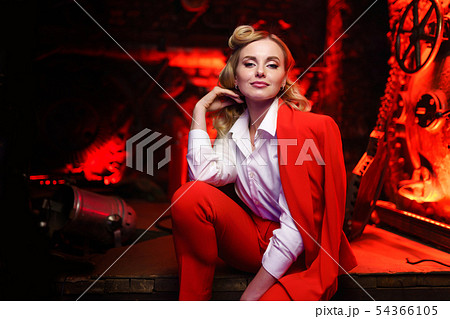 Photo of young blonde woman in red jacket in nightclub Photo of young blonde woman in red jacket in nightclub 54366105