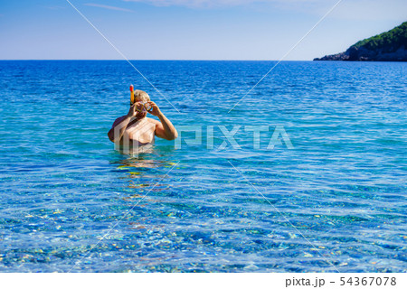 Man with snorkeling tube in sea 54367078