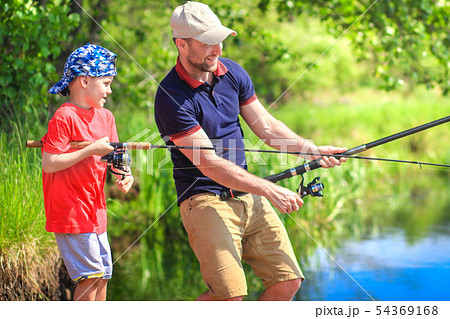 Fishermen on riverside with fishing rods. Father 54369168