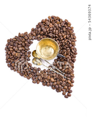 Heart of coffee beans and antuque cup and spoons Heart of coffee beans and antuque cup and spoons 54369374