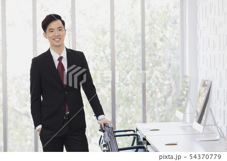 Asian Businessman standing and posing in office.. Asian Businessman standing and posing in office.. 54370779