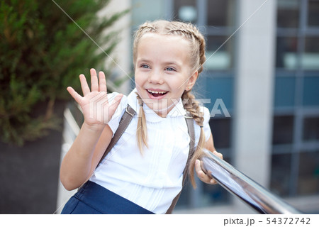 Happy smiling girl is going to school for the first time with bag go to elementary school 54372742