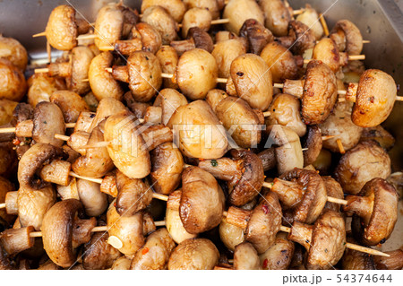 Grilled champignon mushrooms fried on fire 54374644