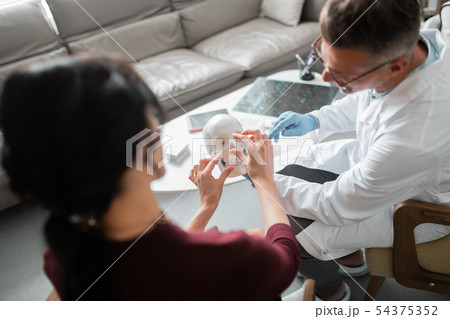 Client of plastic surgeon asking questions about nasal surgery Client of plastic surgeon asking questions about nasal surgery 54375352