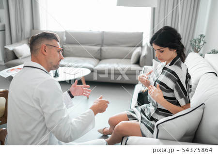 Plastic surgeon consulting client about breast correction Plastic surgeon consulting client about breast correction 54375864