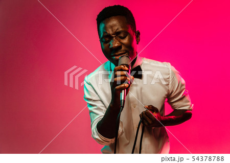 Young african-american jazz musician singing a song 54378788