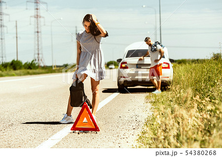 Young couple traveling on the car in sunny day Young couple traveling on the car in sunny day 54380268