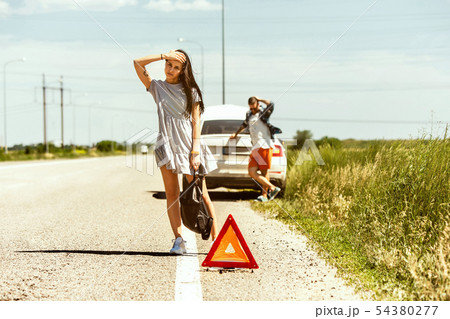 Young couple traveling on the car in sunny day 54380277