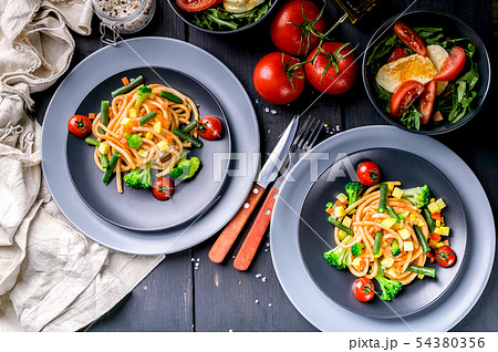 Italian pasta with vegetables and salad 54380356