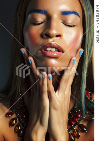 young pretty modern african american girl with bright fashion makeup and ethnic jewelry closeup young pretty modern african american girl with bright fashion makeup and ethnic jewelry closeup 54382974