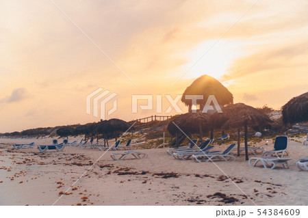 Idyllic tropical beach with white sand, turquoise ocean water and big palm trees 54384609