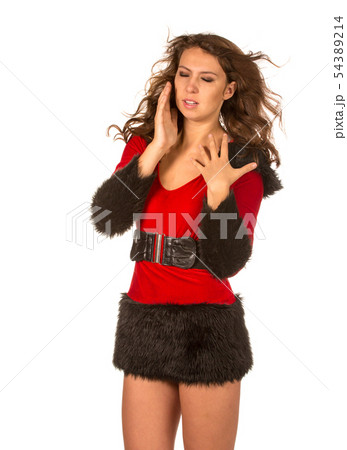 Girl in a New Year's suit struggling with the wind Girl in a New Year's suit struggling with the wind 54389214