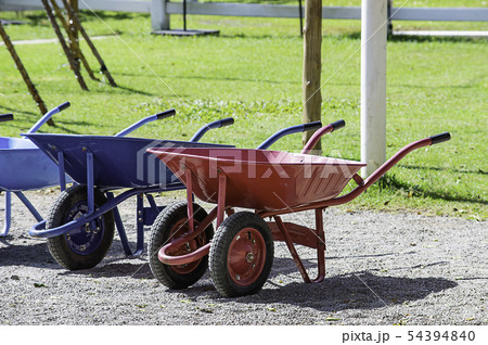 wheelbarrow carts colorful material on the floor. wheelbarrow carts colorful material on the floor. 54394840