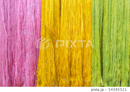 Thai silk threads fiber in pink, green and yellow Thai silk threads fiber in pink, green and yellow 54395521