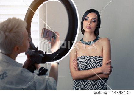 Makeup artist bsn photographs on a mobile phone Makeup artist bsn photographs on a mobile phone 54398432