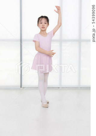 Pink dressed Asian girl in a ballet pose.. 54399096