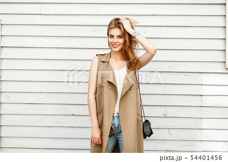 Beautiful young woman smiling in a stylish vest 54401456