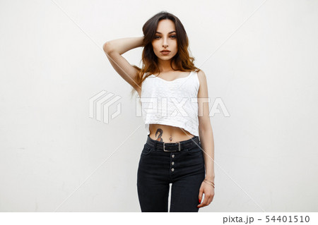 Beautiful young woman in a white tunic shirt Beautiful young woman in a white tunic shirt 54401510