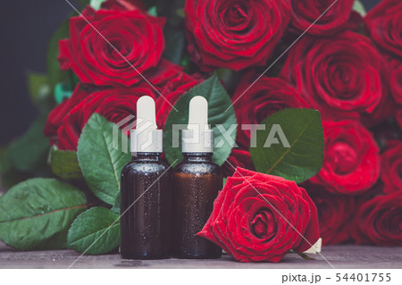 Rose oil, Bottles  and fresh flower and leaves 54401755