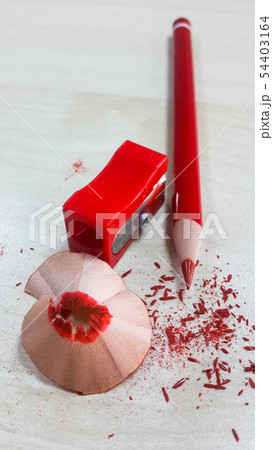 Red pencil and sharpener, isolated on wood backgro 54403164