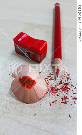 Red pencil and sharpener, isolated on wood backgro 54403165