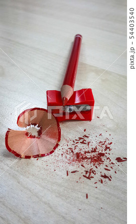 Red pencil and sharpener, isolated on wood backgro 54403540