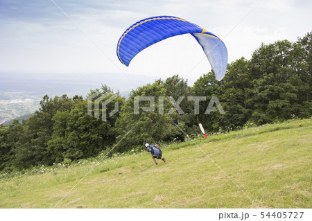 Paraglider taking off from the edge of the 54405727