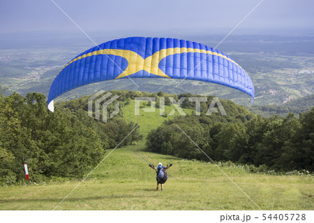 Paraglider taking off from the edge of the 54405728